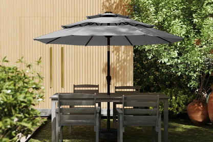 Outdoor patio set with table and chairs under a large gray umbrella in a garden setting.