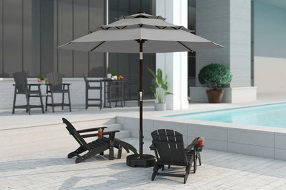 Outdoor patio scene with a large gray umbrella, chairs, and a pool.