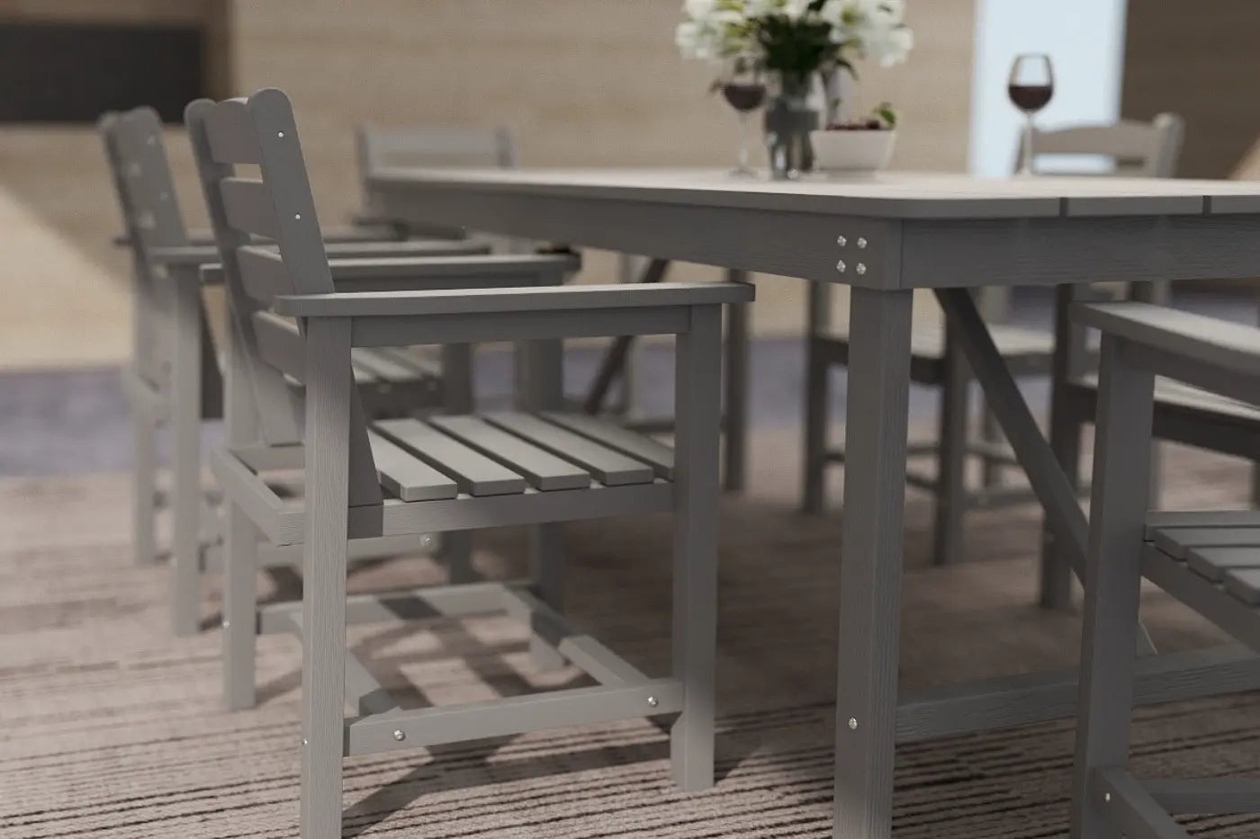 Outdoor furniture set with gray chairs and table on a wooden deck.