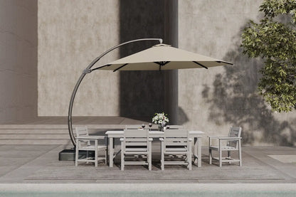 Outdoor dining set with a beige umbrella on a patio area.