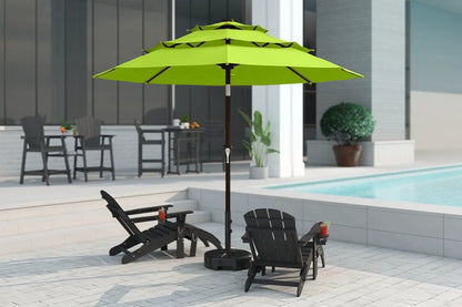 Green patio umbrella with black stand on a patio area near a pool.