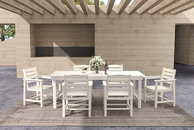 Outdoor dining set with a table and chairs on a wooden deck.