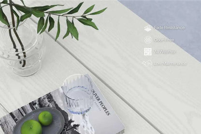 Table setting with a vase, apples, and a magazine on a white surface.