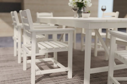 White outdoor dining table and chairs on a wooden deck