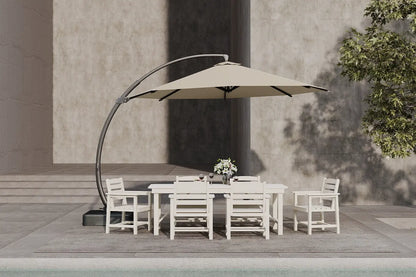 Outdoor patio set with a beige umbrella, table, and chairs on a concrete patio.