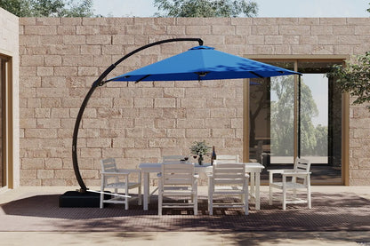 Outdoor patio set with a blue cantilever umbrella in front of a stone wall.