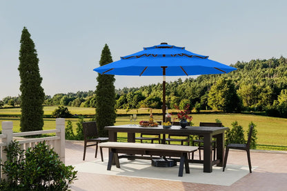 Outdoor dining set with a blue umbrella in a scenic park setting