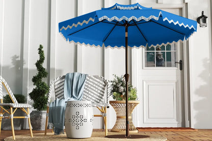 Blue patio umbrella with white trim on a wooden deck