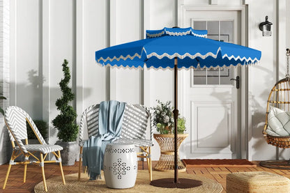 Blue patio umbrella with white trim on a wooden deck
