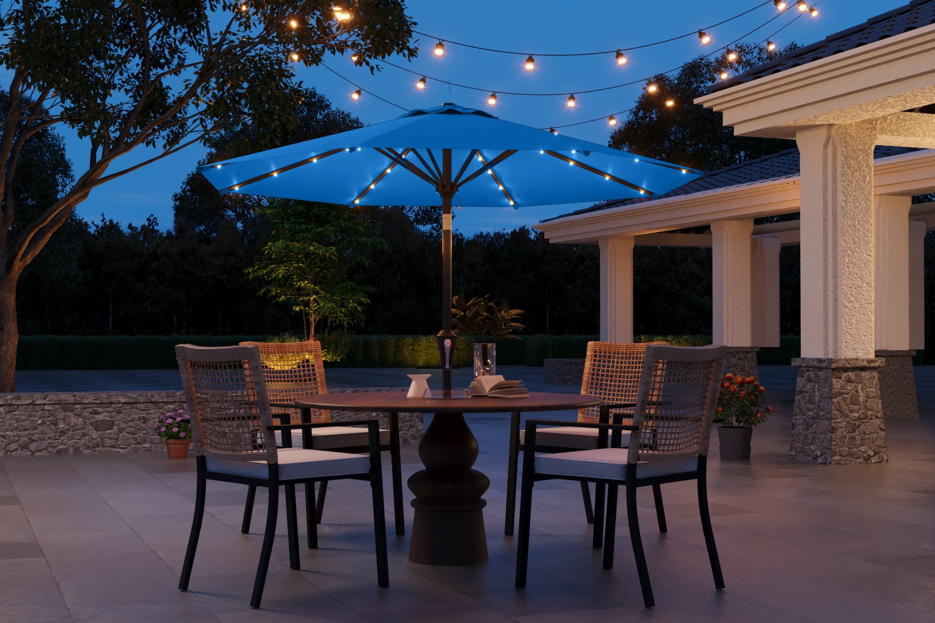 Outdoor patio setting with a table, chairs, and string lights at dusk.