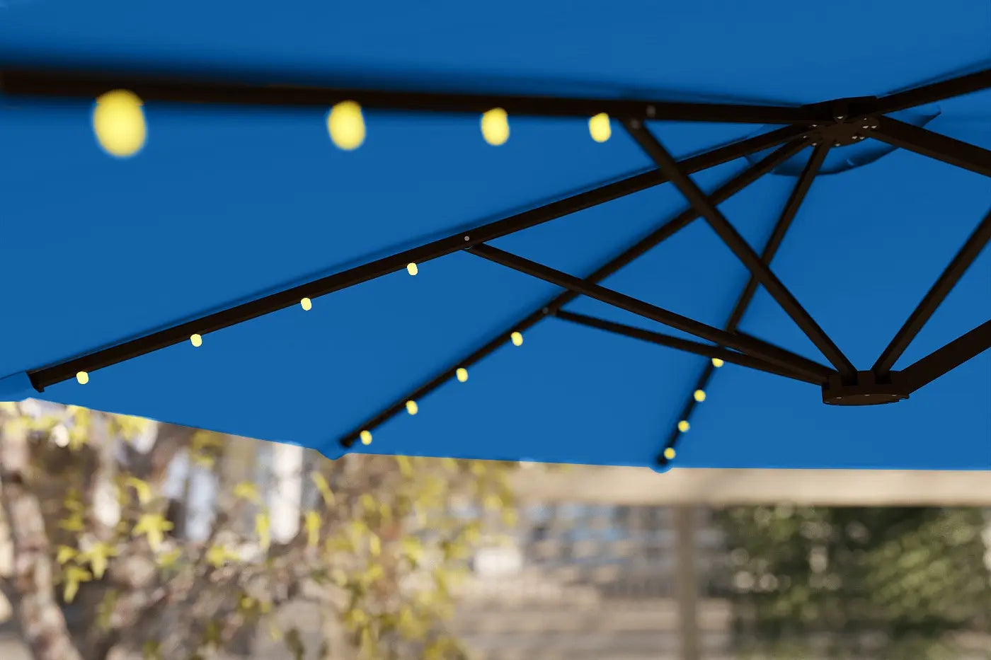 Blue patio umbrella with string lights against a blurred outdoor background