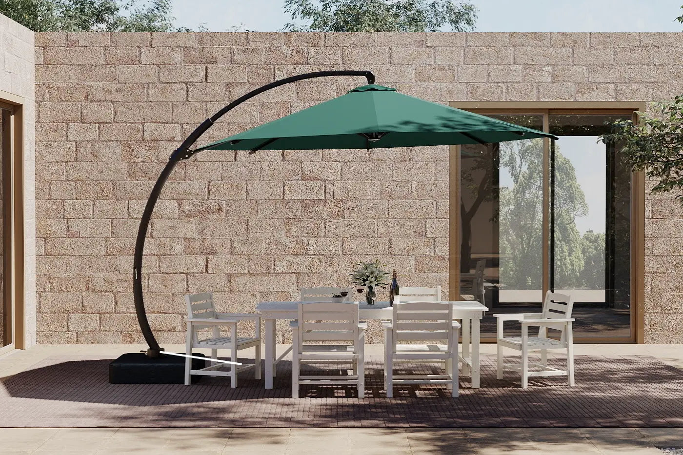 Outdoor patio set with a green cantilever umbrella against a stone wall.