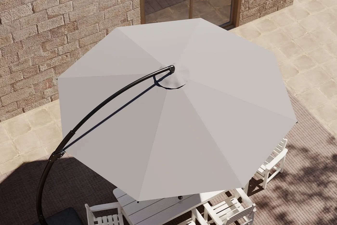 Beige patio umbrella on a table with a stone wall background