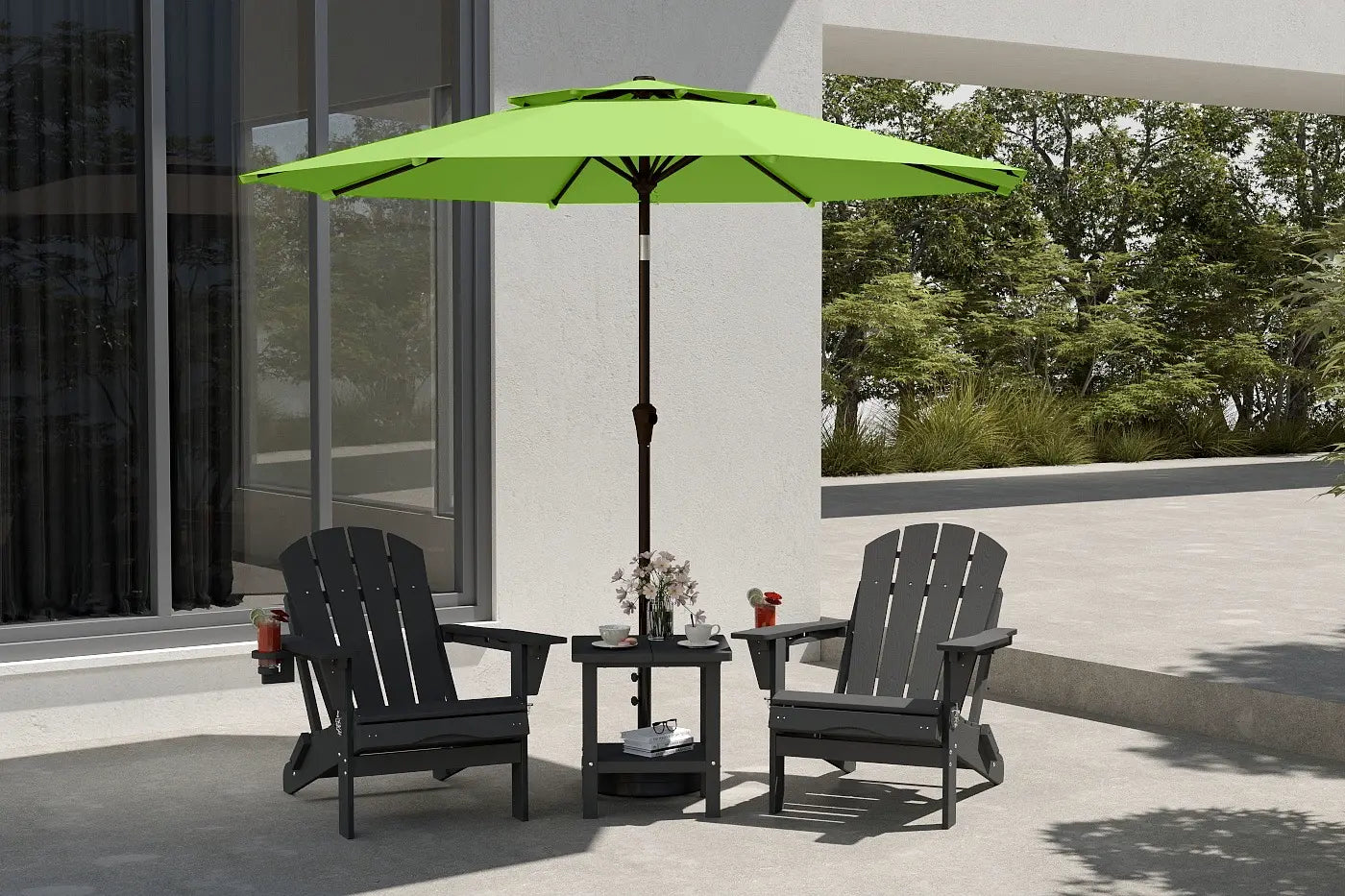 Outdoor patio set with black chairs and a green umbrella on a patio.