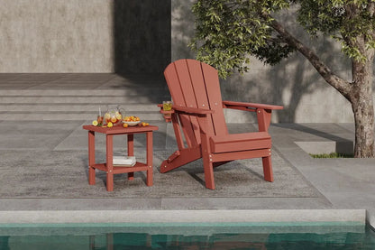 Red Adirondack chair and side table by a poolside with a tree in the background.