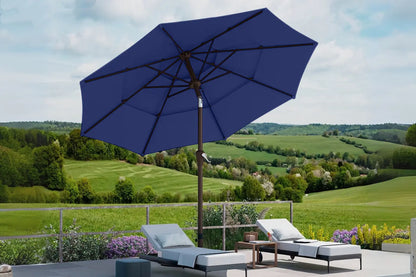 Blue patio umbrella with lounge chairs and a scenic background