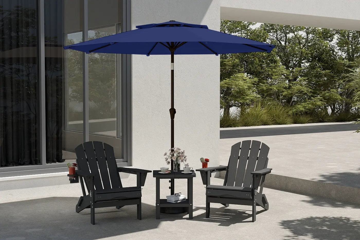 Outdoor patio set with two black chairs and a blue umbrella on a concrete patio.