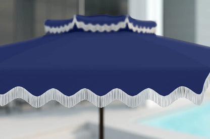 Blue outdoor umbrella with white trim against a blurred background