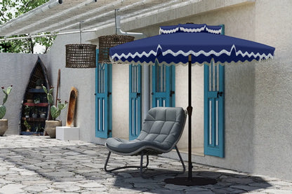 Blue outdoor umbrella with white trim over a gray chair on a patio.