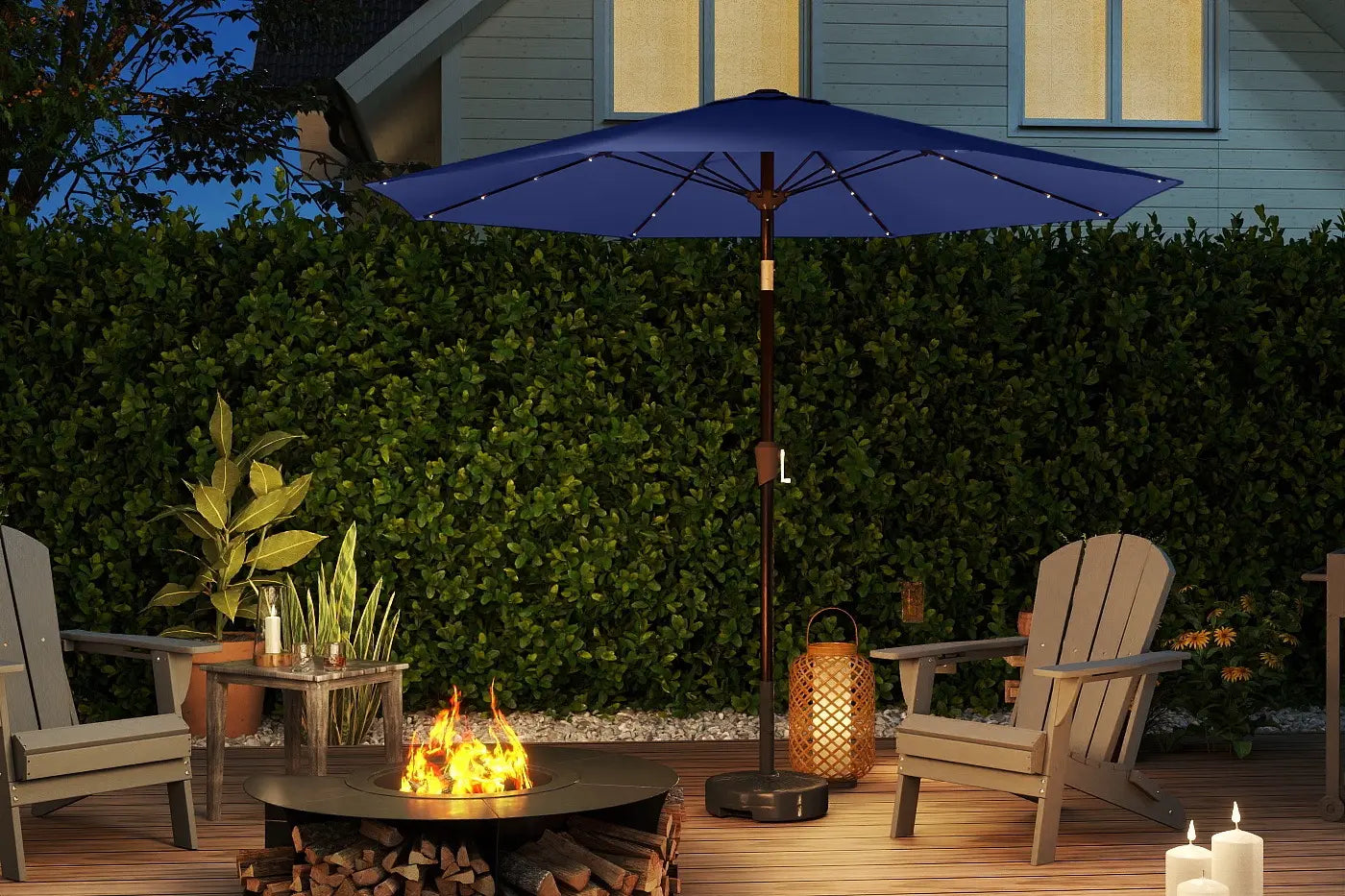 Outdoor patio scene with a fire pit, chairs, and a blue umbrella.