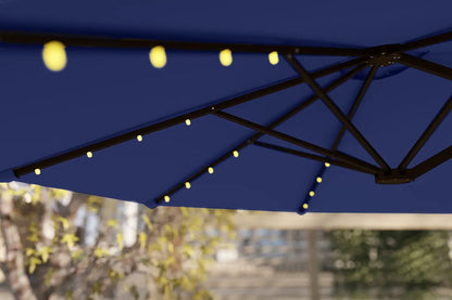 Blue patio umbrella with string lights against a blurred outdoor background