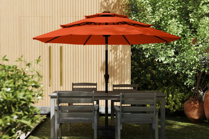 Outdoor patio set with a large red umbrella in a garden setting.