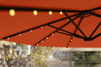 Red patio umbrella with string lights against a blurred outdoor background