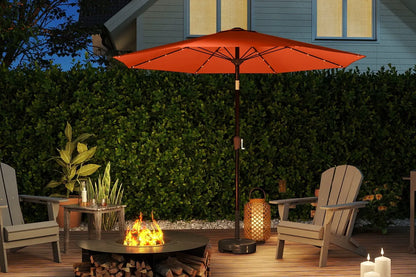 Outdoor patio setting with a red umbrella, fire pit, and Adirondack chairs.