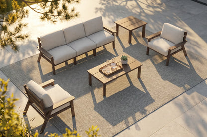 Outdoor furniture set with a sofa, chairs, and coffee table on a patio.