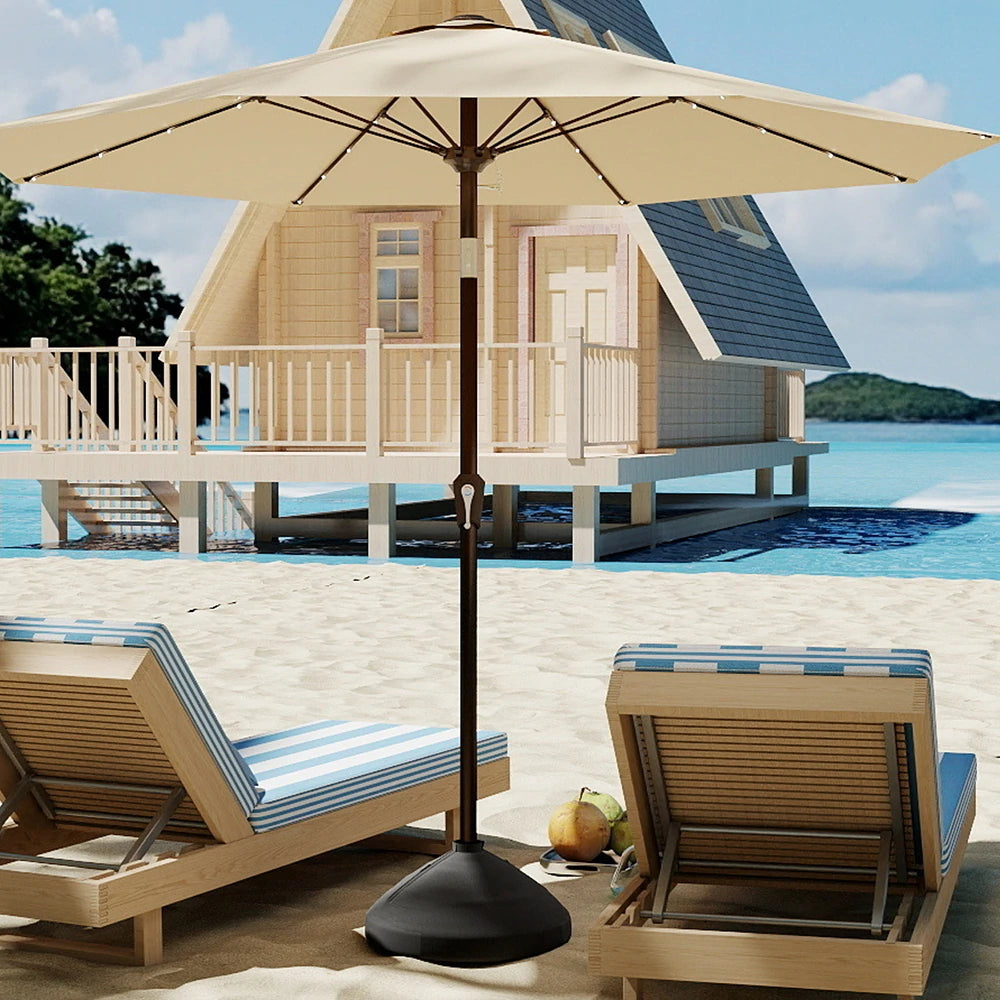 Beach scene with wooden lounge chairs, umbrella, and overwater bungalow.