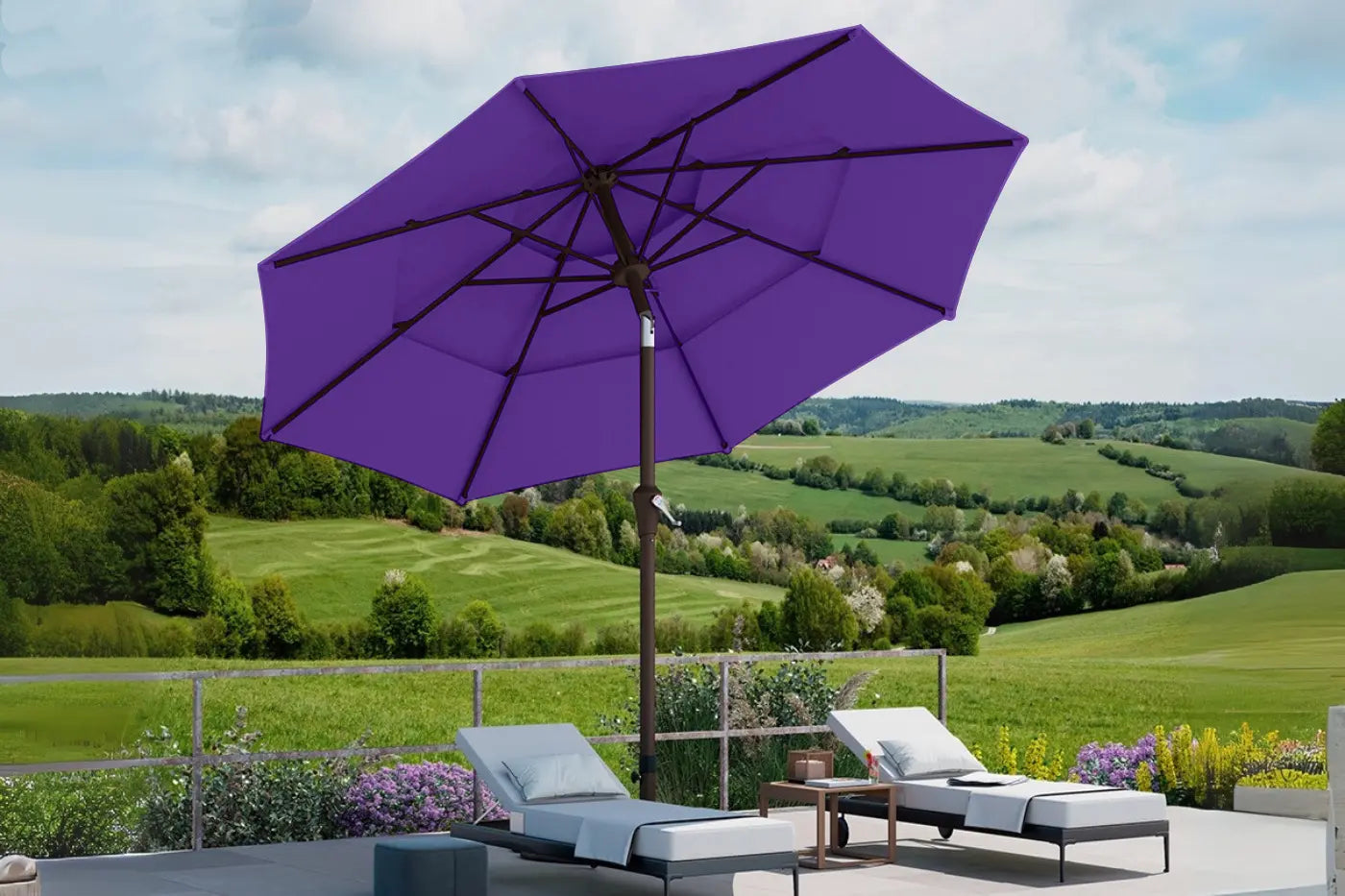 Purple patio umbrella on a patio with a scenic view of green fields and trees.