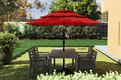 Outdoor patio set with a red umbrella in a garden setting