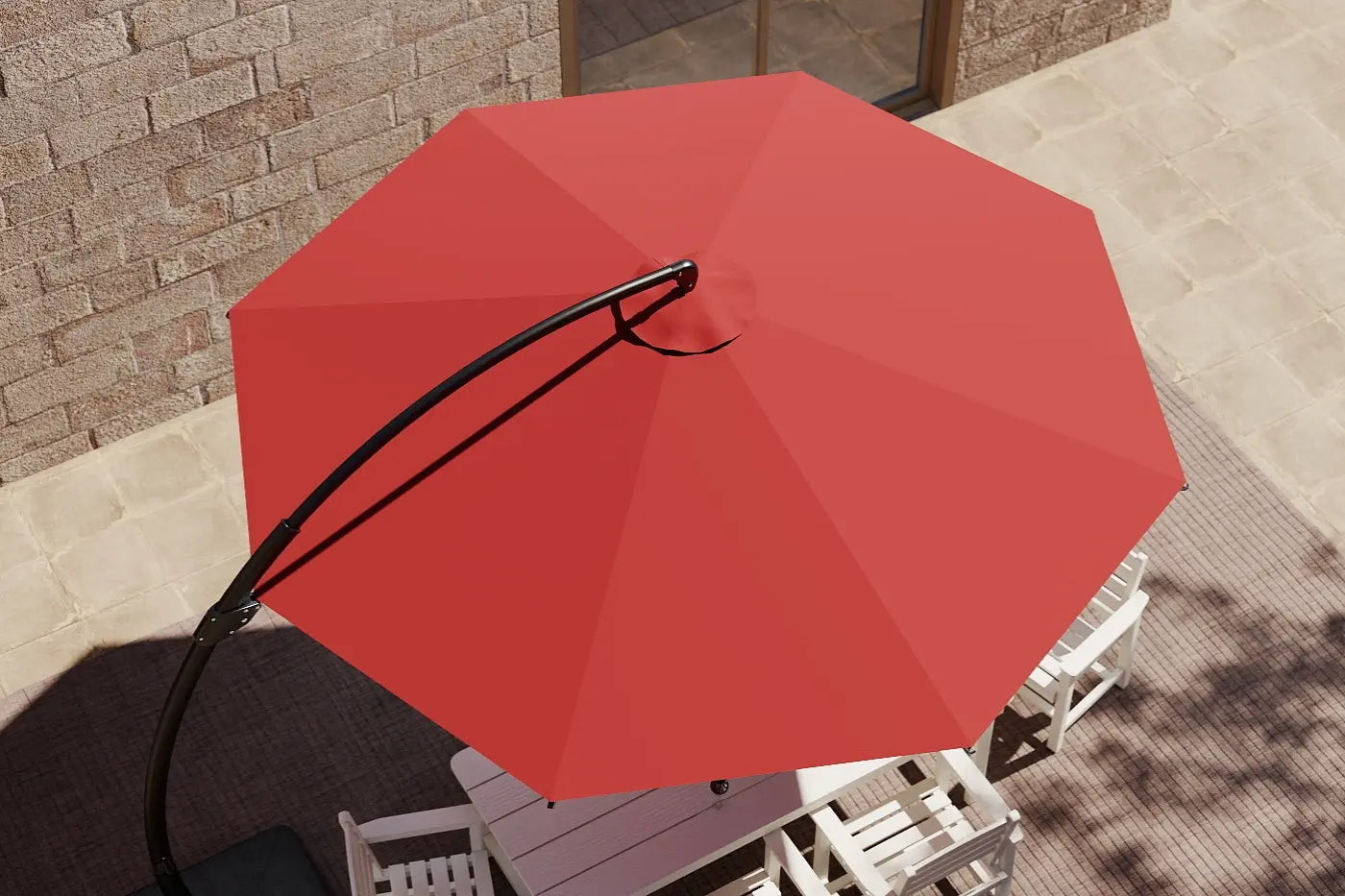 Red patio umbrella on a patio with chairs and a table.
