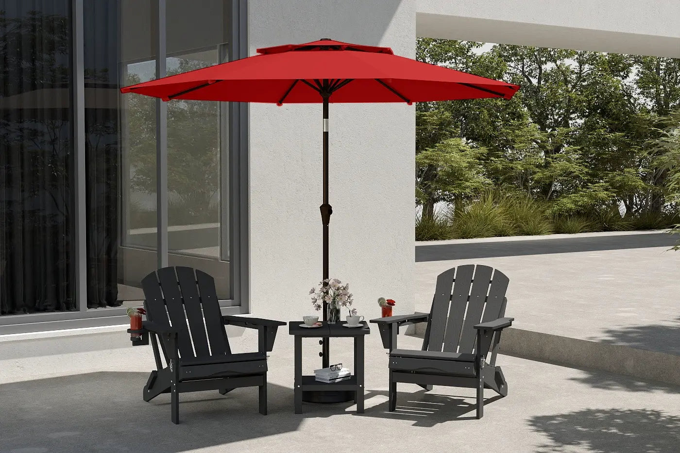 Red patio umbrella over two black chairs on a patio with a building and trees in the background.