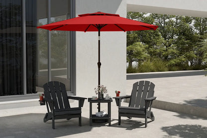Red patio umbrella over two black chairs on a patio with a building and trees in the background.