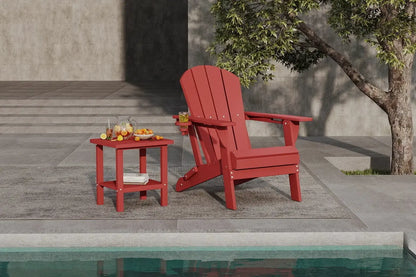 Red Adirondack chair and side table by a poolside with a tree in the background.
