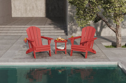 Two red Adirondack chairs with a small table by a poolside.