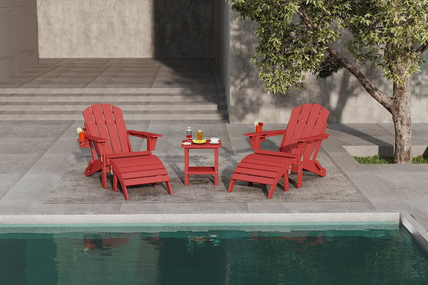 Red Adirondack chairs and a small table by a poolside with a tree in the background.