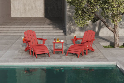 Red Adirondack chairs and a small table by a poolside with a tree in the background.