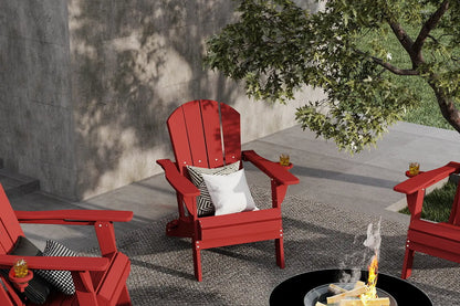 Red Adirondack chairs around a fire pit on a patio with a tree and wall in the background.