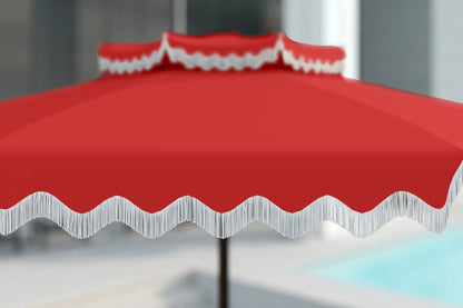 Red outdoor umbrella with a wavy edge on a blurred background