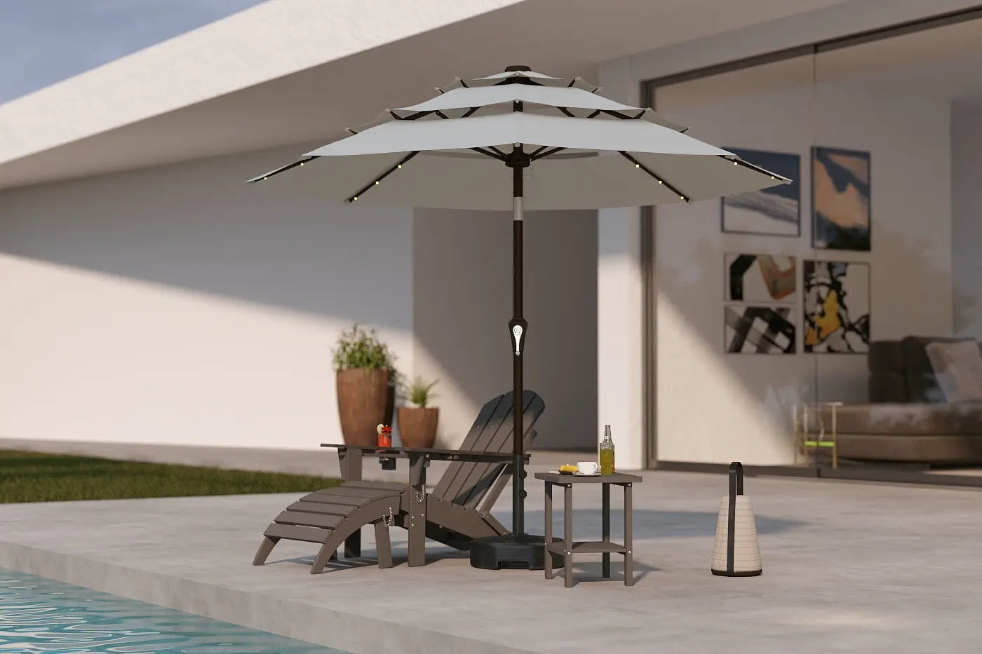 Outdoor patio scene with a large umbrella, lounge chair, and side table near a pool.