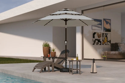 Outdoor patio scene with a large umbrella, lounge chair, and side table near a pool.
