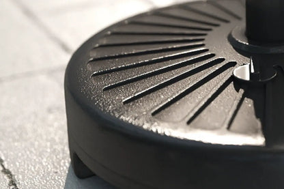 Close-up of a black grill pan on a paved surface