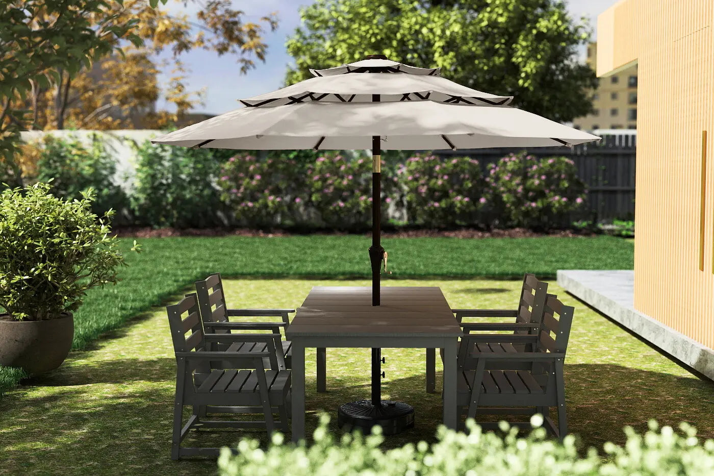 Outdoor patio set with table and chairs under a large umbrella on a grassy area.