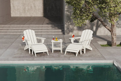 Two white Adirondack chairs by a pool with a small table holding drinks.