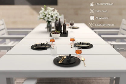 White outdoor dining table set with black plates and silverware, featuring fade resistance, odor-free, all-weather, and low-maintenance attributes.