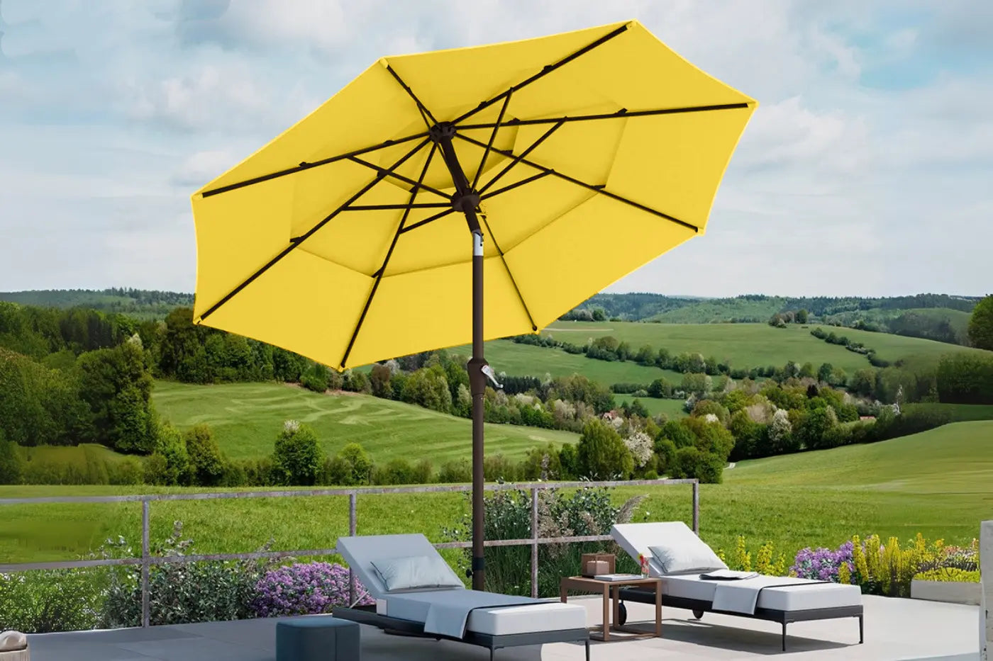 Yellow patio umbrella with lounge chairs and a scenic background