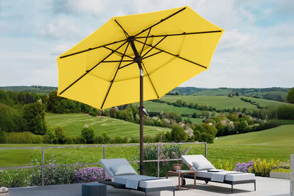 Yellow patio umbrella with lounge chairs and a scenic background
