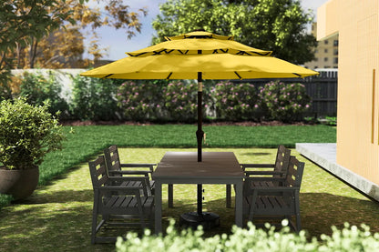 Outdoor patio set with a yellow umbrella and wooden table on a grassy area.